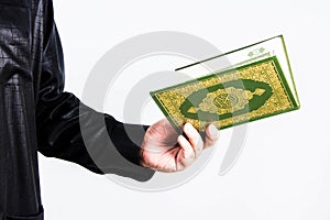 Koran in hand ,Quran in hand - holy book of Muslims , on white background