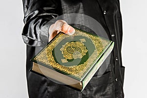 Koran in hand ,Quran in hand - holy book of Muslims , on white background