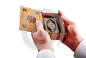 Koran, islam holy book hold by male hands