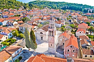 Korcula island. Town of Vela Luka church tower and rooftops aerial view