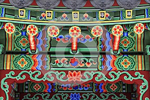 Korean architecture - colorful wooden roof of gazebo painted in traditional Korean floral style