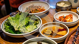 Korean barbecue sidedish with green lettuce, pickle and Kimchi