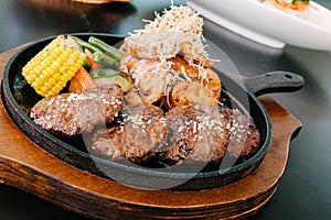 Korean bbq sizzle plate with other dishes in the background