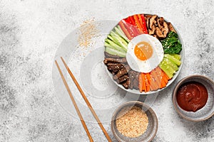 Korean Bibimbap. Traditional Korean food. Top view, flat lay. Light grunge background