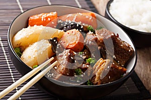 Korean Braised Beef Short Ribs with rice garnish close-up. horizontal