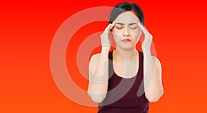 Korean,chinese woman`s headache severely, suffering asian woman,girl isolated on red background