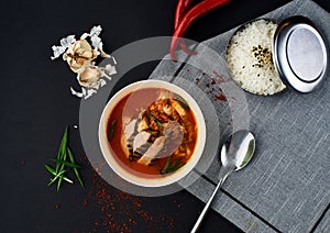 Korean cuisine. Kimchi soup on black background.