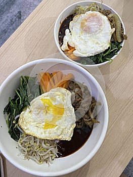 Korean dish named Bibimbap with rice, vegetables, egg and beef