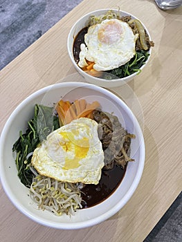 Korean dish named Bibimbap with rice, vegetables, egg and beef