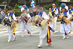 Korean drummers in colorful traditional dress.