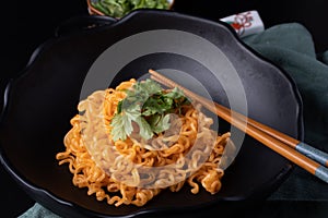 Korean dry noodle in black bowl