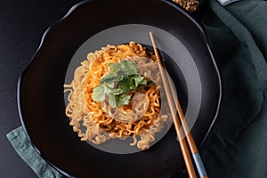 Korean dry noodle in black bowl