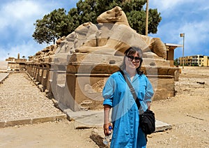 Korean female tourist and Avenue of the Sphinxes from the first pylon of the Karnak Temple in Luxor, Egypt.