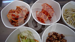 Korean food side dishes Banchan multiple small portions top view angle video kimchi bean sprouts vegetable