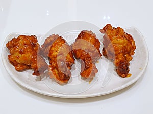 Korean food style, Top view of spicy chicken on white plate in restaurant