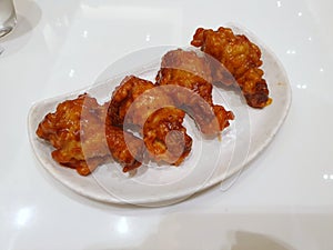 Korean food style, Top view of spicy chicken on white plate in restaurant