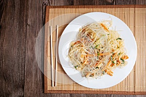 Korean funchosa salad with shrimps on a bamboo napkin