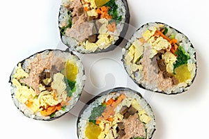 Korean gimbap rolls isolated on white background close-up, top view photo