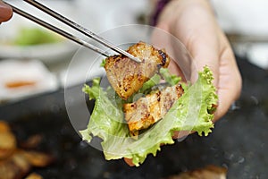 Korean grilled pork belly BBQ Samgyeopsal Gui - The popular Korean barbecue dish, served with fresh lettuce and a spicy dipping