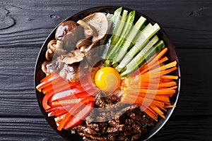 Korean healthy food Bibimbap of rice with fried beef, raw egg, v