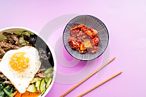 Korean Kimchi with bi bim bap on pink background. Top view