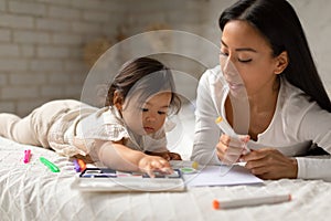 Korean Mommy And Baby Daughter Painting Together At Home