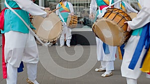 Korean national festival. A group of musicians and dancers in bright colored suits perform traditional Korean folk dance