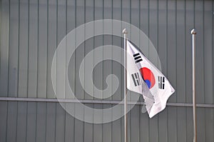 Korean National flag Taegeukgi flies in front of the building in the park in Autumn