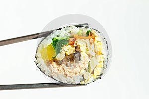 Korean roll gimbap and chopsticks on white background close-up. photo