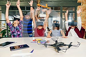 Korean scientist with the group of young pupils with laptop and VR headsets during a computer science class. Excited