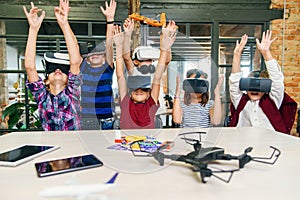 Korean scientist with the group of young pupils with laptop and VR headsets during a computer science class. Excited