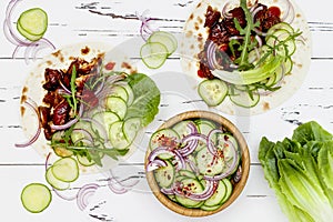 Korean slow cooked beef tacos with asian cucumber slaw and sriracha ketchup. Top view, flat lay