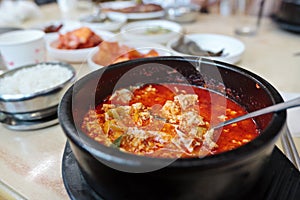 Korean spicy tofu soup sundubu jjigae in a hot pot photo