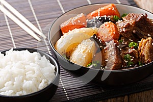 Korean stewed beef short ribs with vegetables and rice garnish c