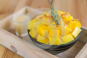 Korean style fresh mango shaved ice on wood table .