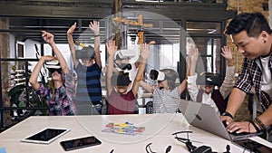 Korean teacher with group young pupils with laptop and VR headsets during a computer science class