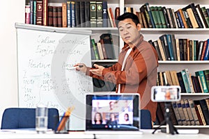 Korean Teacher Teaching Group Of Students Via Video Call Indoor