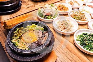 Korean traditional dish- bibimbap mixed rice with vegetables Include beef and fried egg and pickles set