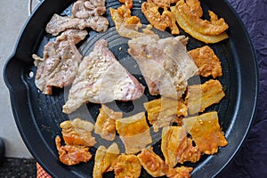 Korean traditional grilled BBQ food, samgyupsal, pork with gochujang and Grilled Pork Neck on hot pan, Food for camping in winter