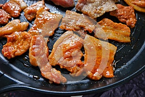 Korean traditional grilled BBQ food, samgyupsal, pork with gochujang and Grilled Pork Neck on hot pan, Food for camping in winter