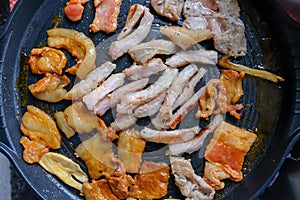 Korean traditional grilled BBQ food, samgyupsal, pork with gochujang and Grilled Pork Neck on hot pan, Food for camping in winter