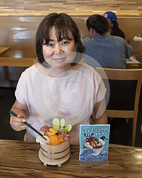 Korean woman enjoying dinner in a restaurant in Seattle, Washington