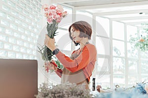 Korean woman Florist cutting bouquet of flowers