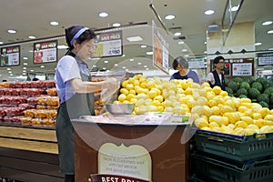 Korean woman slicing fruit.