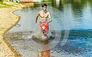 Korean young man running on water with a smile and a naked torso