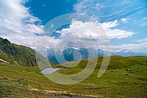 Koruldi lakes in Caucasus mountains, Mestia, Svaneti region, Georgia. Summer day, green hills, high mountain pasture for livestock