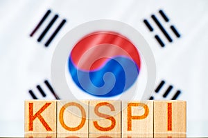 kospi index KOREA. wooden blocks with the inscription kospi on the background of the korea flag. photo