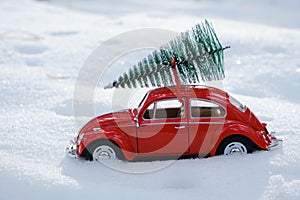 Kostanay, Kazakhstan 2022.Red Volkswagen beetle with spruce on roof, against background white snow