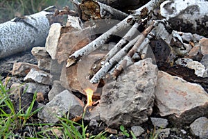 Koster from birch branches a small flame