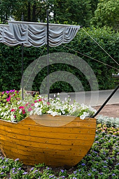 Kostroma, Russia, July 8, 2023. Stylized boat with flowers in the park.